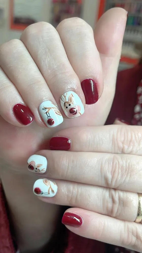 Burgundy and white festive reindeer nail art at JK Nails Chester
