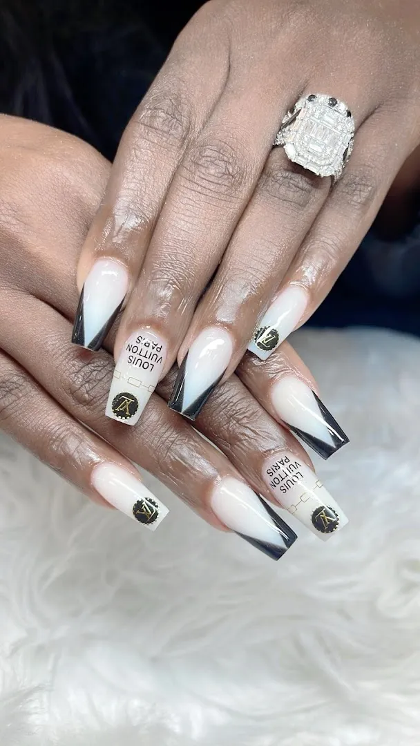 Black and white ombré French nails with gold monogram art and a diamond ring