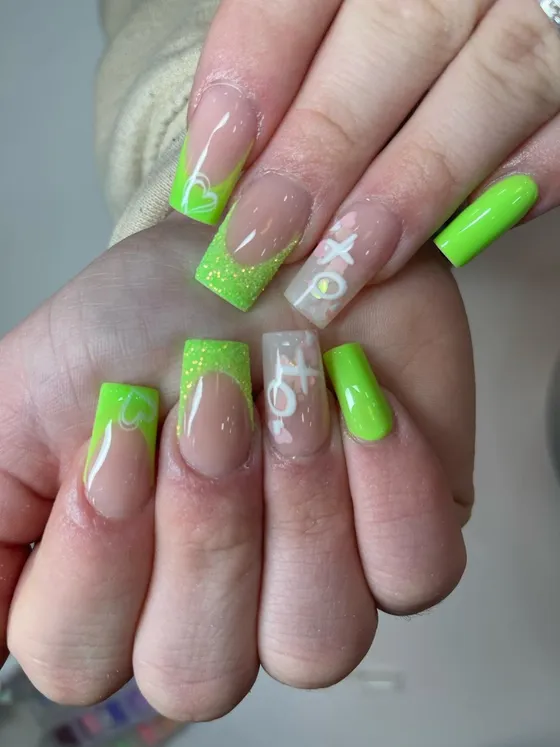 Neon green glitter nails with white XO heart art at JK Nails Chester