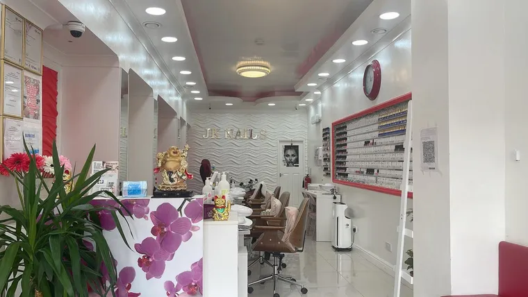 Inside JK Nails Chester — a bright, spacious modern nail bar with the JK Nails name on the wall